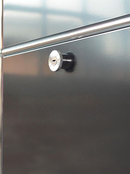 Close-up of a lock on a black steel cabinet