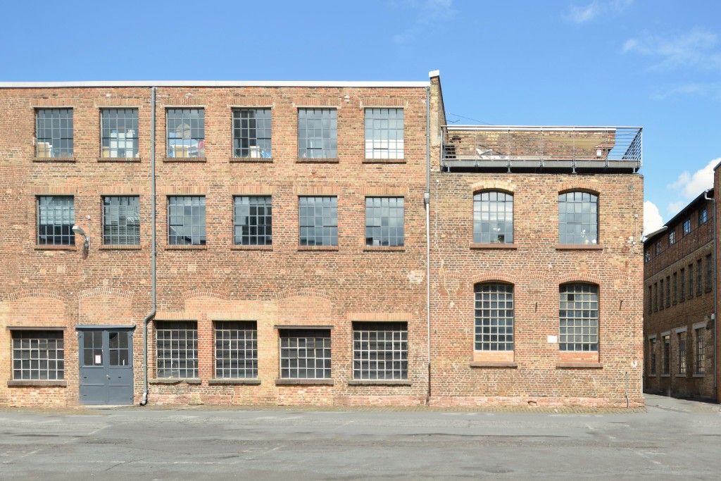Brick facade with factory windows and a roof terrace