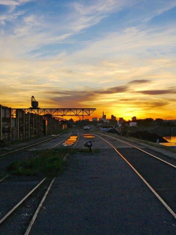 Rails at Offenbach harbour at sunset, with the Frankfurt skyline on the horizon