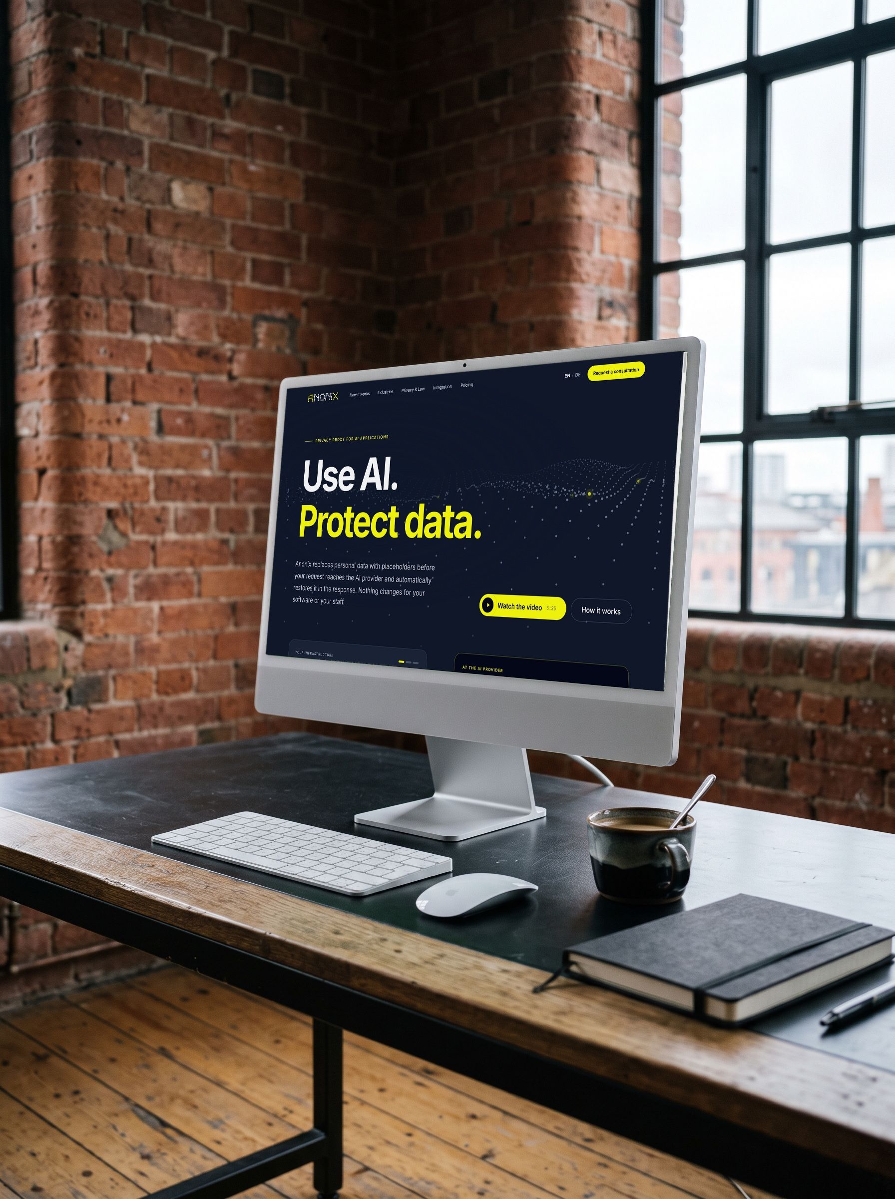 Screen on a wooden desk in a loft with a brick wall, showing the Anonix home page with a wave of dots in the background and the headline “Use AI. Protect data.”