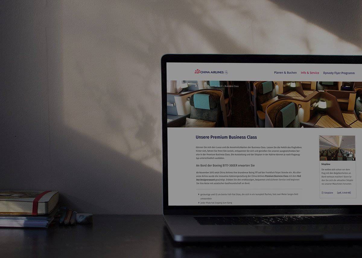 Laptop on a table showing the Premium Business Class page of the China Airlines website