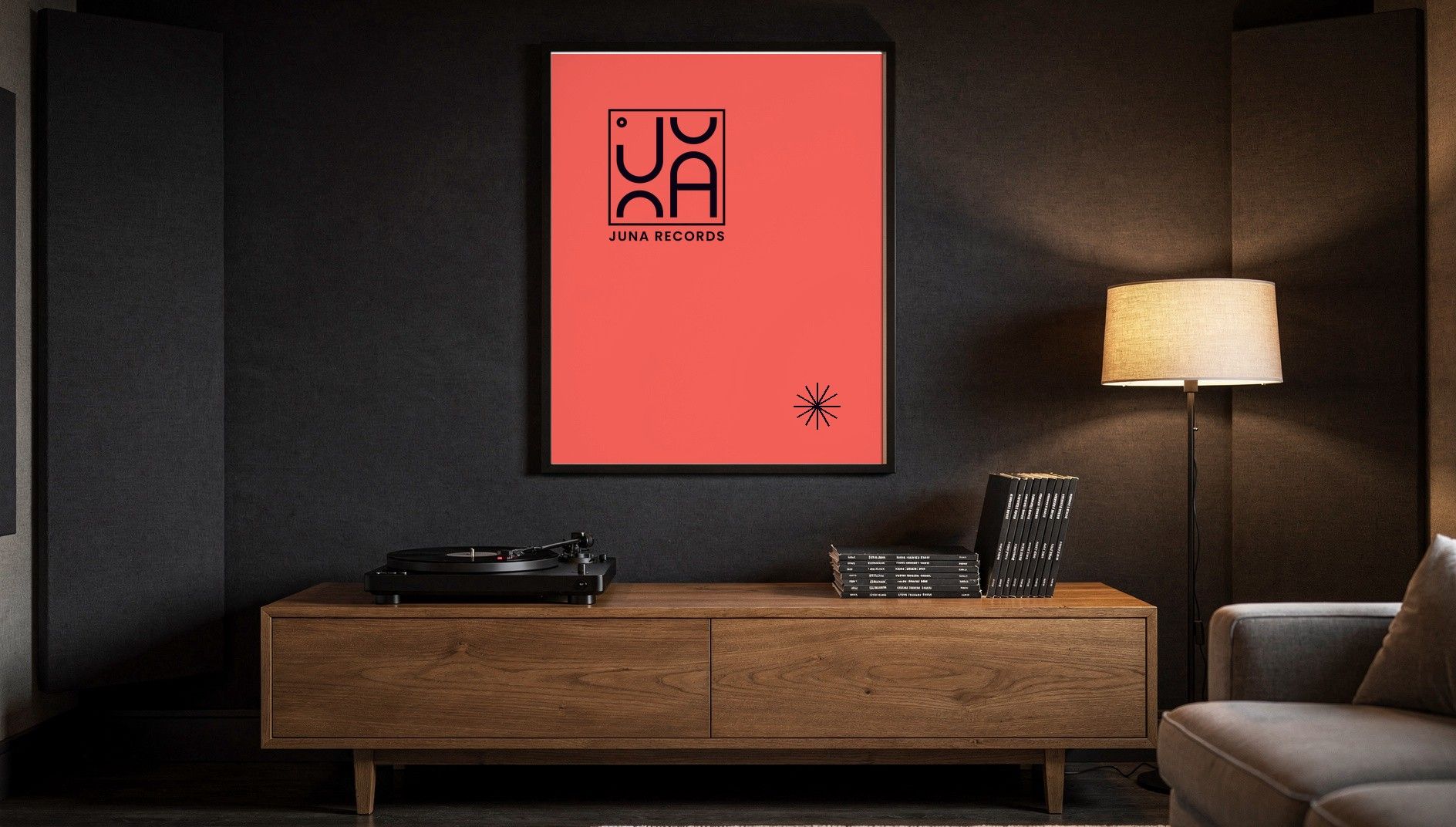 Coral poster with the black JUNA RECORDS logo in a studio, a turntable on a wooden sideboard below