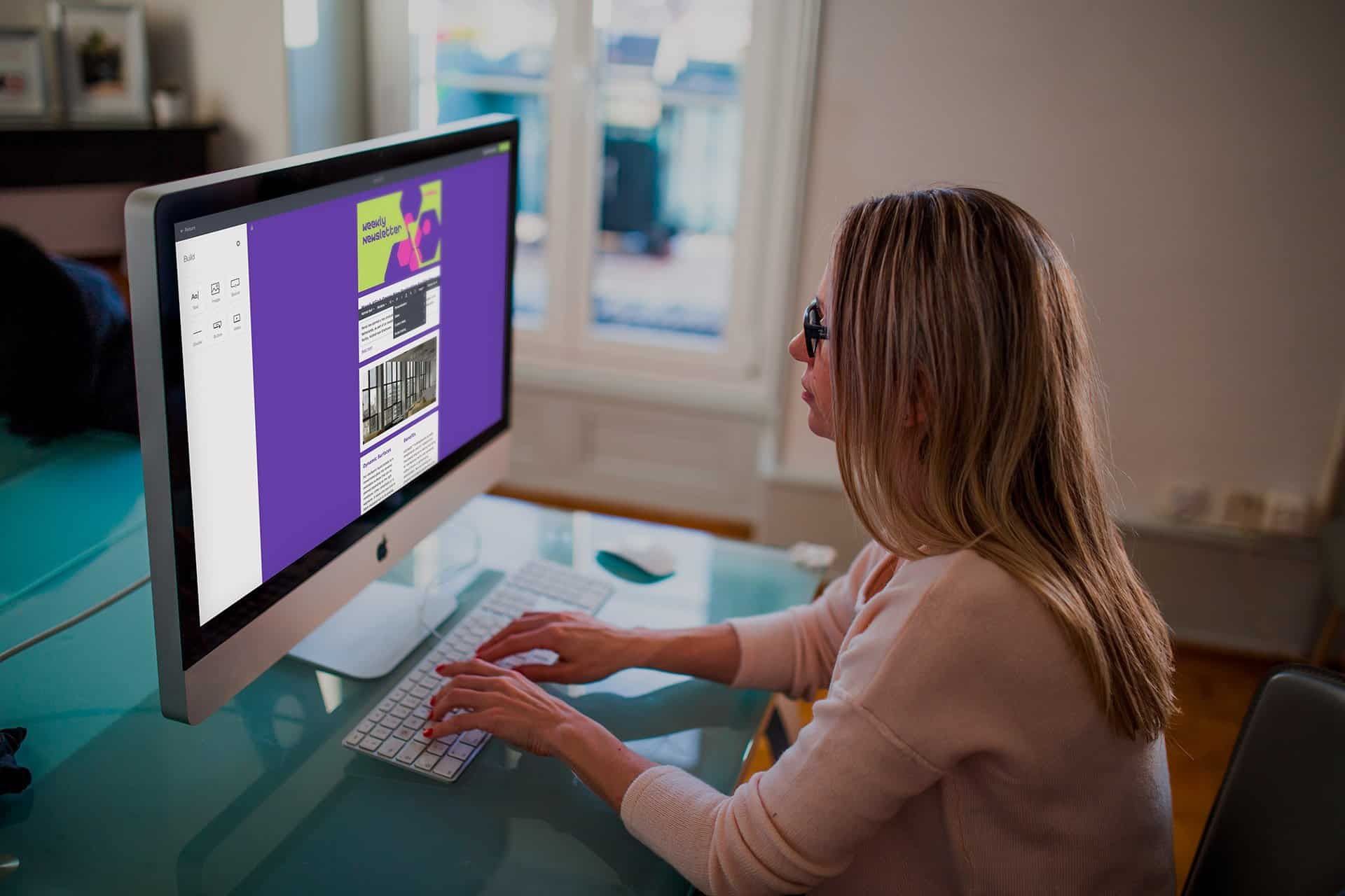 Woman building a Merck KGaA newsletter in the drag and drop editor on a desktop screen